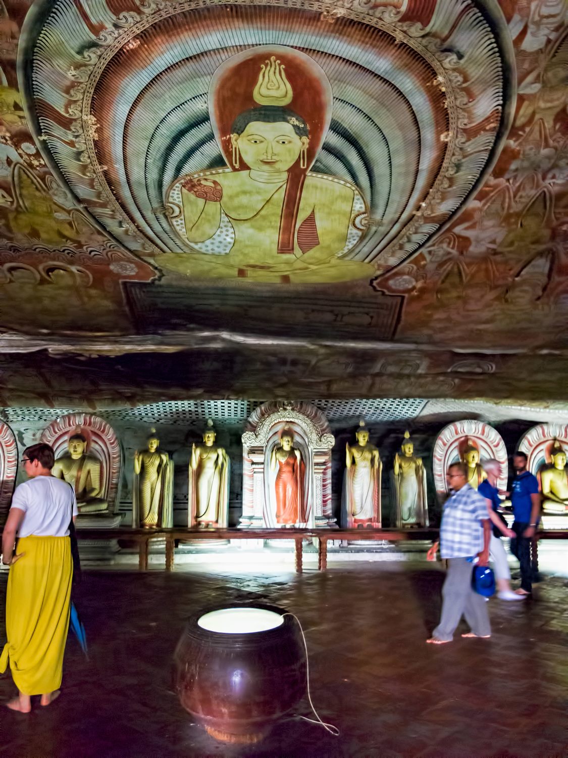 Painted rock ceiling in the Dambulla cave temple, following the natural contours of the stone.
