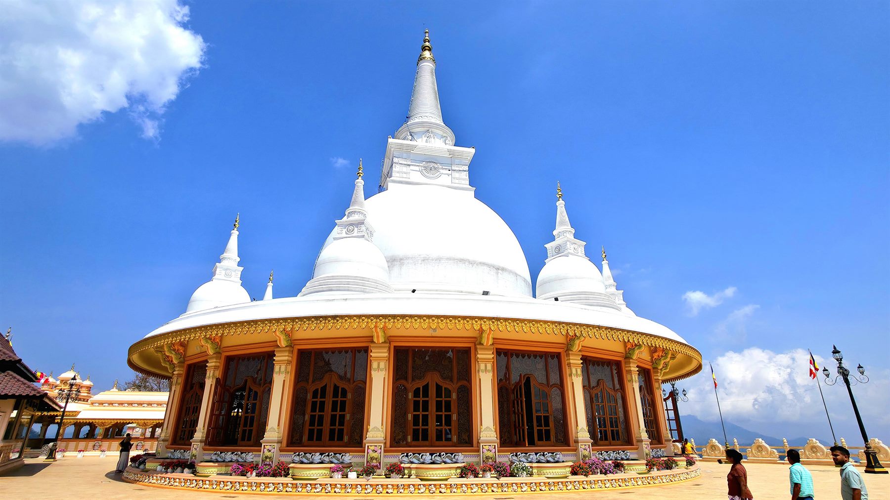 A large white stūpa at a Sri Lankan Buddhist monastery in the hill country.