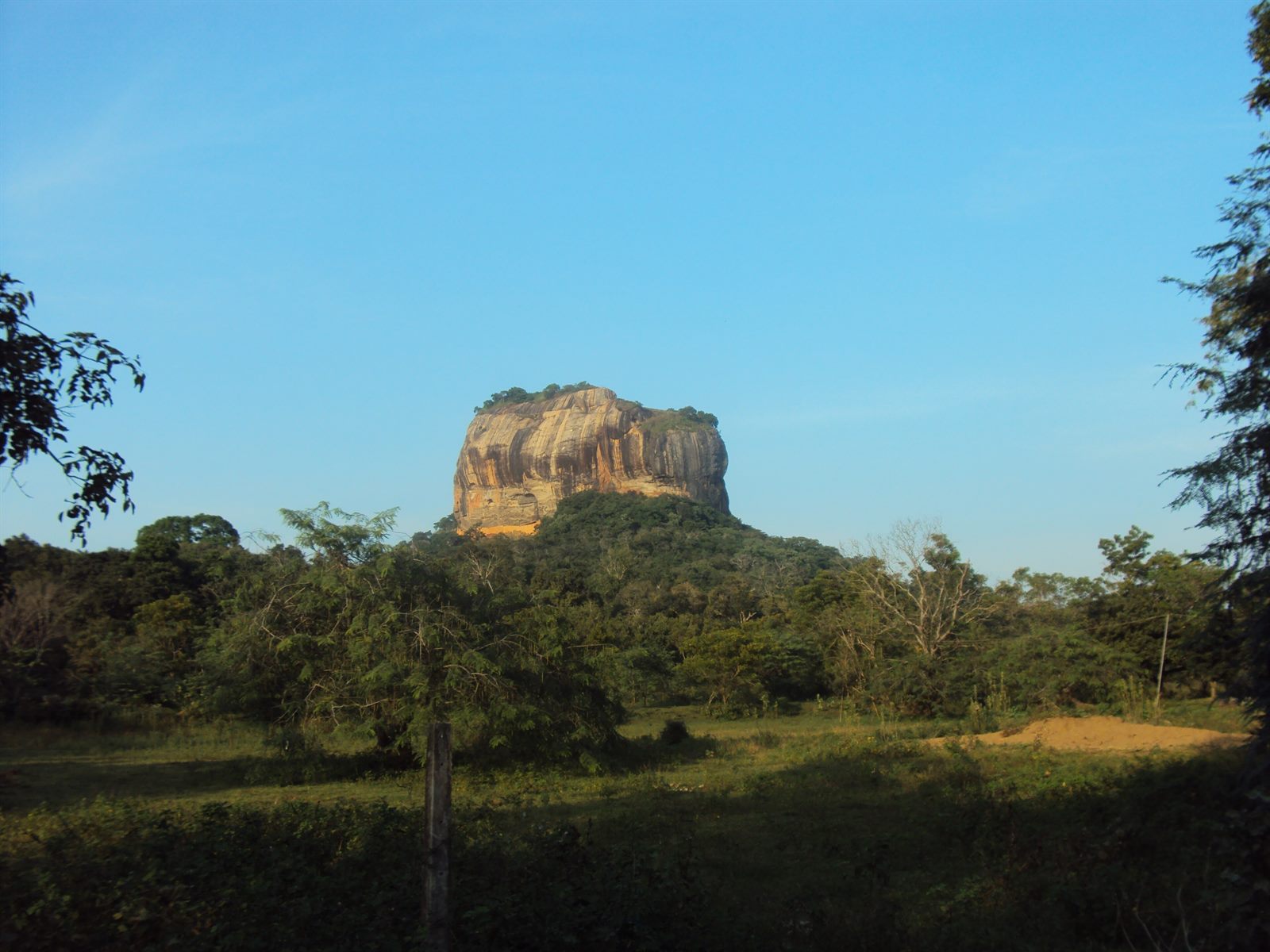 The rock fortress of Sīgiriya rising from the surrounding plain.