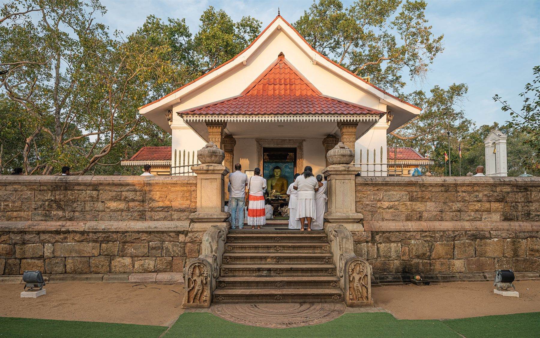 The Jaya Sri Mahā Bodhi at Anurādhapura, the sacred fig tree on its walled terrace, hung with prayer flags.